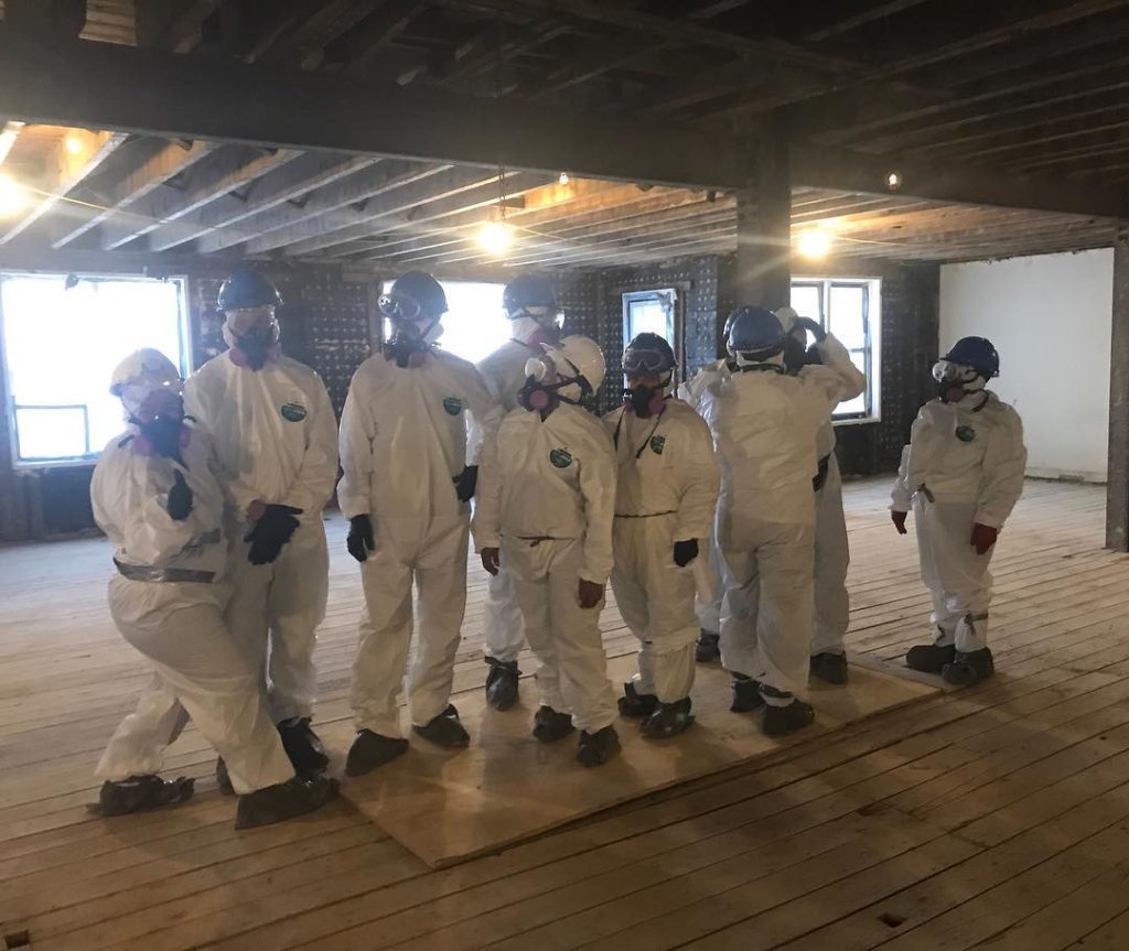 bowerman cleaning and restoration team doing a pose in their hazmat suits