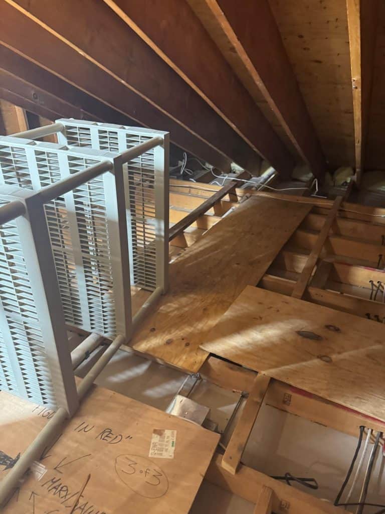 View down attic access stairs showing removed insulation during mold remediation in Scarsdale, NY
