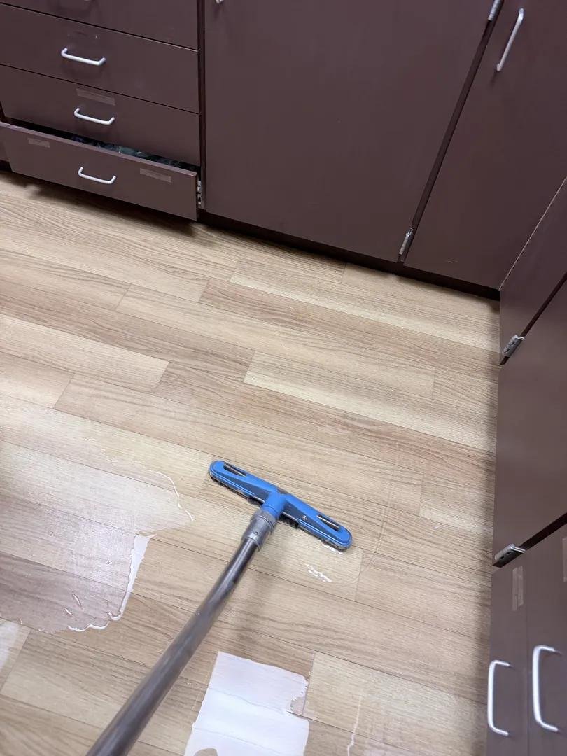 Water extraction on an exam room floor during dental office water damage restoration in Armonk, NY