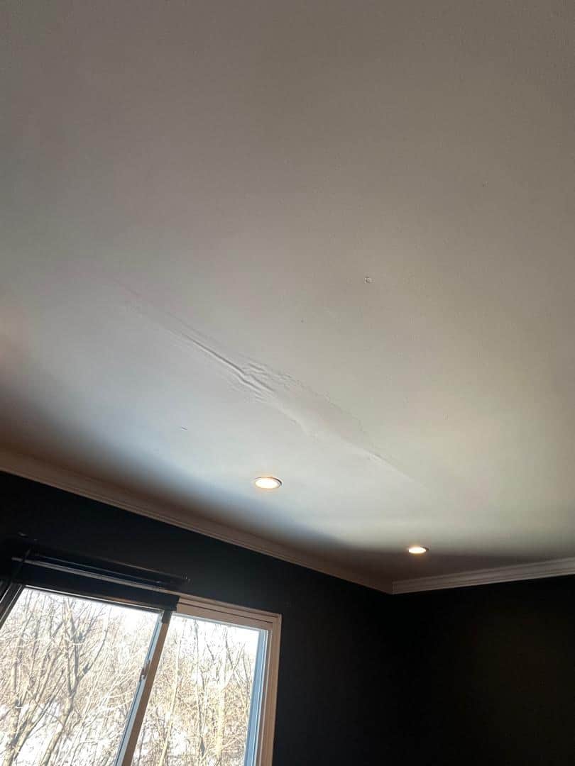 Water-stained, sagging ceiling caused by an ice dam leak before drying