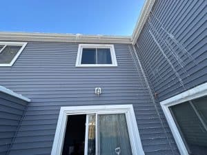 Ice buildup along the roofline and siding of a home causing ice dam water damage